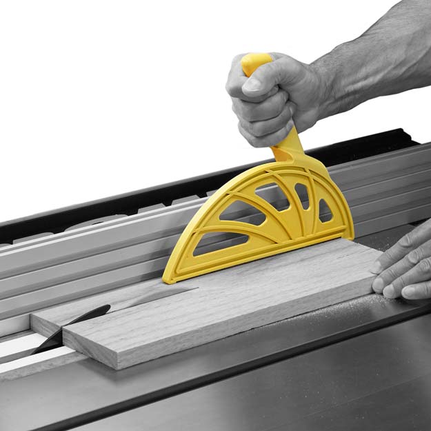 Hedgehog push block safely ripping a board on a table saw with a narrow cut. Has offset handle.